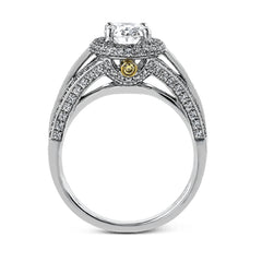 This lovely 18k white gold engagement ring design is created for an elegant oval center stone and features .77 ctw of white diamonds accented by a small touch of .03 ctw of yellow diamonds.