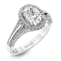 This lovely 18k white gold engagement ring design is created for an elegant oval center stone and features .77 ctw of white diamonds accented by a small touch of .03 ctw of yellow diamonds.