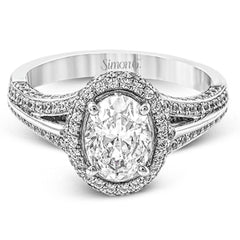 This lovely 18k white gold engagement ring design is created for an elegant oval center stone and features .77 ctw of white diamonds accented by a small touch of .03 ctw of yellow diamonds.
