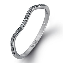 This dramatic white gold engagement ring and wedding band set are highlighted by .23 ctw of dazzling round cut white diamonds in a distinctive modern twist design.