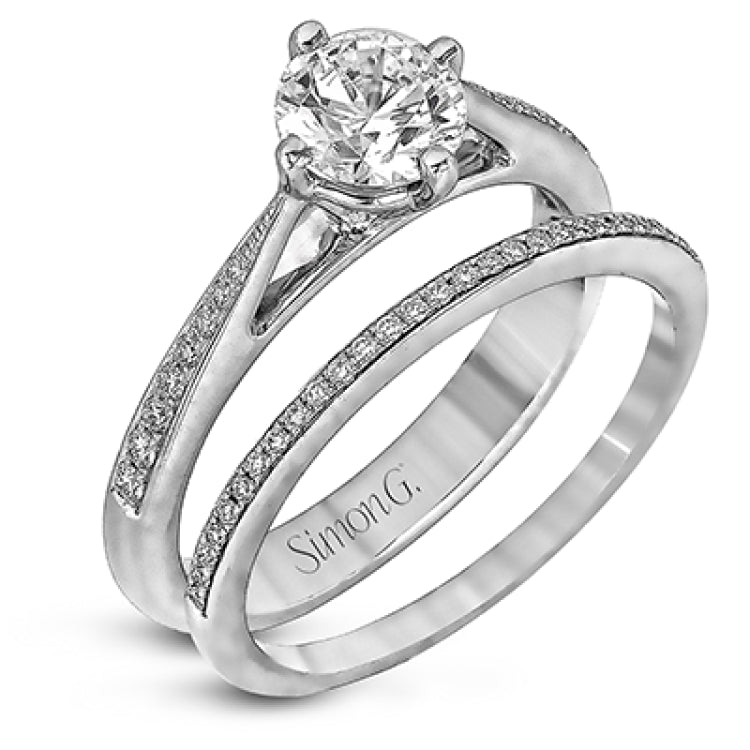 The elegant design of this classic white gold engagement ring and wedding band is complemented by .21 ctw of glimmering round cut white diamonds.