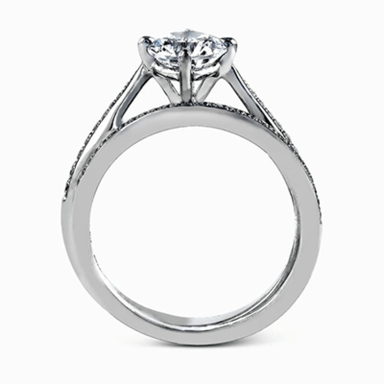 The elegant design of this classic white gold engagement ring and wedding band is complemented by .21 ctw of glimmering round cut white diamonds.