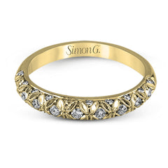 This intricate band has a floral, nature-inspired design and contains .32 ctw of white diamonds.