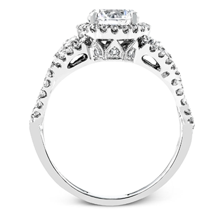 Reflecting an intricate modern design, this remarkable white gold ring is emphasized by a lovely halo complemented with .59 ctw round cut white diamonds.