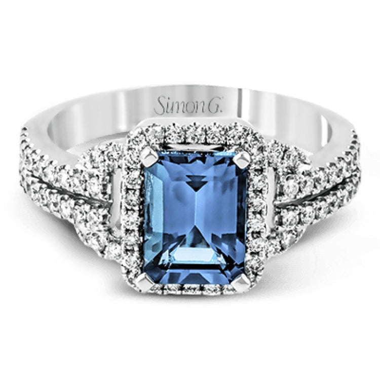 This elegant white gold contemporary ring is set with an arresting 1.31 ctw center aquamarine highlighted by .42 ctw round cut white diamond accents.
