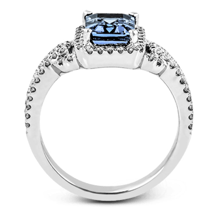 This elegant white gold contemporary ring is set with an arresting 1.31 ctw center aquamarine highlighted by .42 ctw round cut white diamond accents.