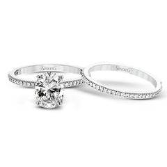 The classic, streamlined design of this 18k white gold wedding set is accented by .30 ctw of sparkling white round brilliant diamonds.