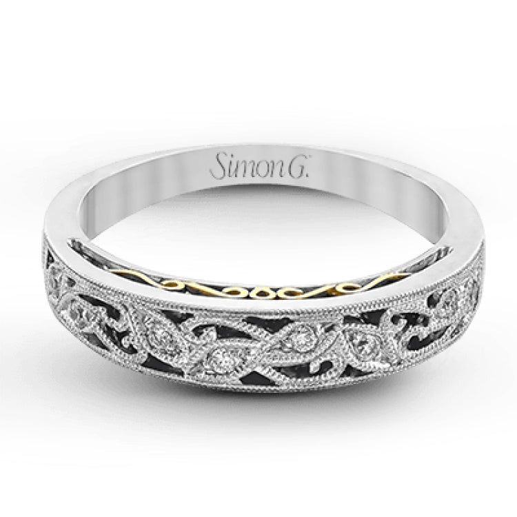 Featuring a delicate, intricate vintage style, this white gold wedding band is set with .09 ctw of shimmering white diamonds.