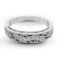 Featuring a delicate, intricate vintage style, this white gold wedding band is set with .09 ctw of shimmering white diamonds.