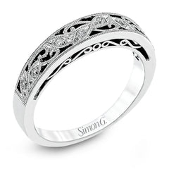 Featuring a delicate, intricate vintage style, this white gold wedding band is set with .09 ctw of shimmering white diamonds.
