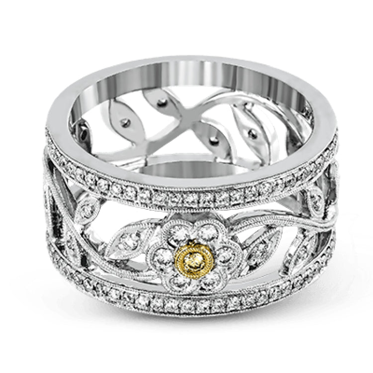 This charming white gold vintage style ring features a lovely floral design accented by .77 ctw of round cut white diamonds and .02 ctw round cut yellow diamonds.