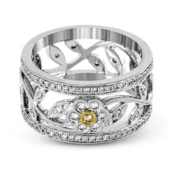 This charming white gold vintage style ring features a lovely floral design accented by .77 ctw of round cut white diamonds and .02 ctw round cut yellow diamonds.