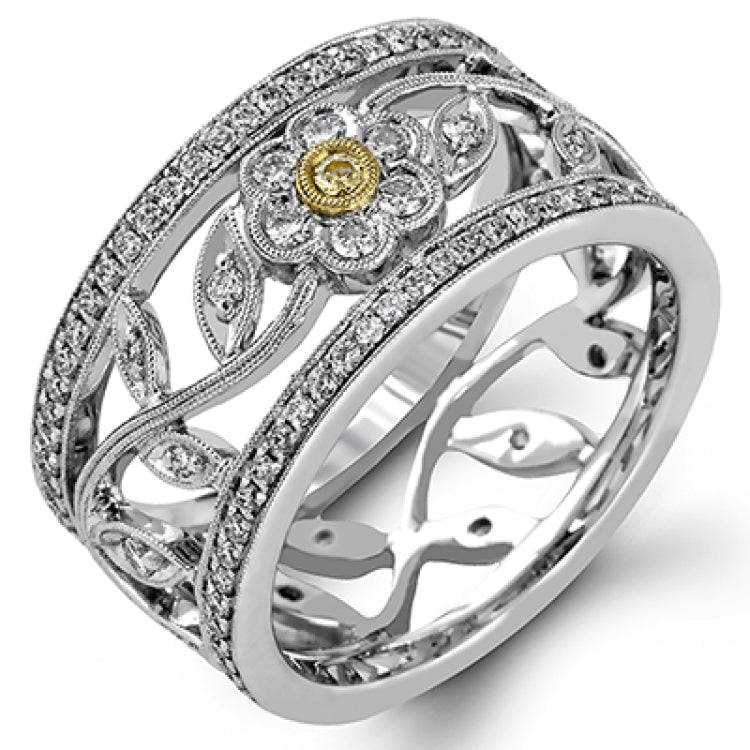This charming white gold vintage style ring features a lovely floral design accented by .77 ctw of round cut white diamonds and .02 ctw round cut yellow diamonds.
