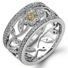 This charming white gold vintage style ring features a lovely floral design accented by .77 ctw of round cut white diamonds and .02 ctw round cut yellow diamonds.