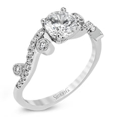 Playful and modern, this white gold wedding set sparkles with .31 ctw of round white diamonds highlighting the center stone.