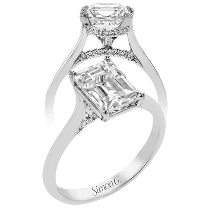 This elegant white gold engagement ring takes an Emerald center and is adorned with a delicate under halo, and a line of diamonds on the side profile 0.13 ctw