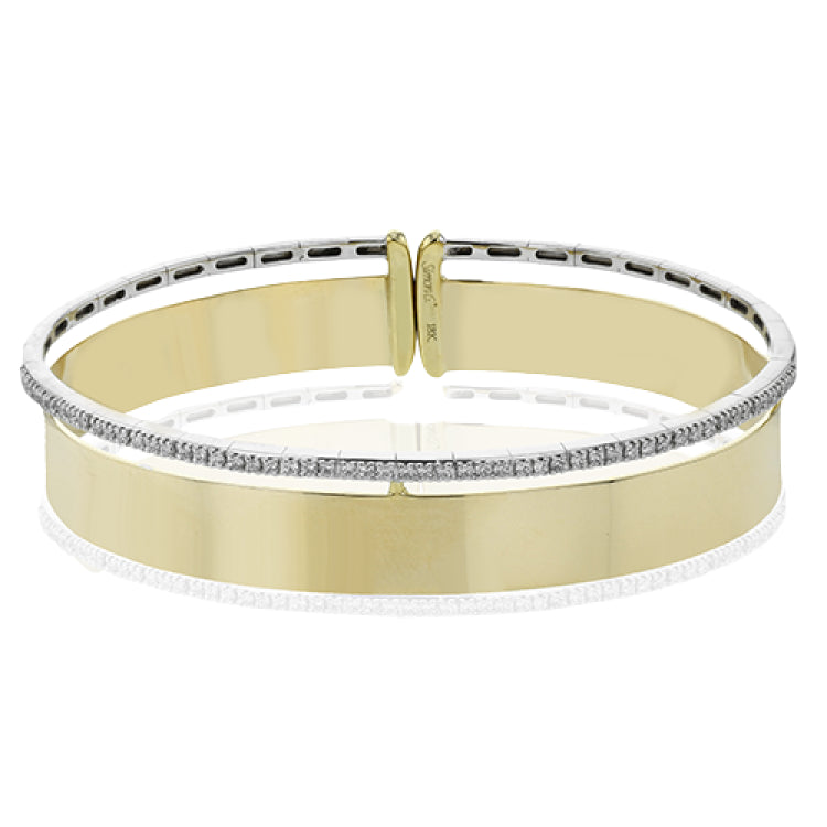 Make a statement with this wide bangle in yellow gold with a brushed finish and accented by a row of white diamonds .40 ctw.