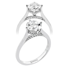 This elegant white gold engagement ring takes an oval center and is adorned with a delicate under halo, and a line of diamonds on the side profile 0.13 ctw