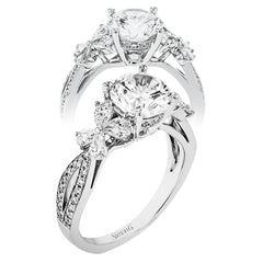 A beautiful engagement ring perfect for those who love floral inspired designs. It features a split shank setting with diamond accents .20ctw., & 8 pear shaped diamonds .62ctw. that create the look of petals around the center stone.