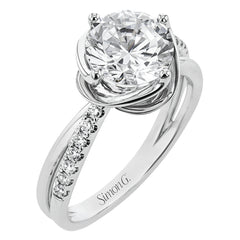 This criss-cross design engagement ring shimmers with 0.15 ctw round diamonds and a halo of gold strands wrapped around the center