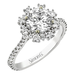 From our Super nova collection this 18K engagement ring is a unique take on the classic halo ring, and features 0.60 ctw of round diamonds