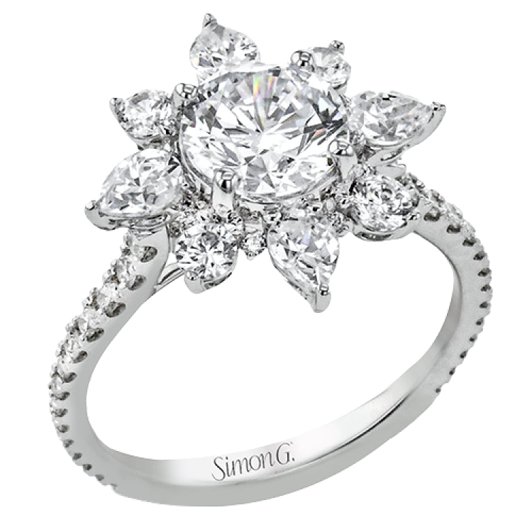 Pear shaped diamonds are set into a pointed halo that expands outward like a cosmic explosion in this Supernova Collection engagement ring.