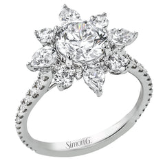 Pear shaped diamonds are set into a pointed halo that expands outward like a cosmic explosion in this Supernova Collection engagement ring.