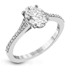Simple yet stunning, this graceful engagement ring is made for an oval cut center stone and is set with .16 ctw of white diamonds.