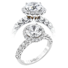 This stunThis stunning halo engagement ring in 18K white gold takes a 2.0 ct center, and has 0.92 ctw of RD brilliant diamonds on the sides & the halo combined.