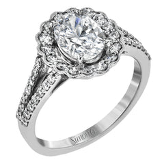 This delightful engagement ring features a scalloped halo that surrounds the center stone like a flower, containing .52 ctw of white diamonds.