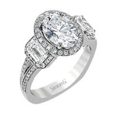 This impressive white gold ring features .43 ctw emerald cut side diamonds and is accented with .38 ctw round cut diamonds.