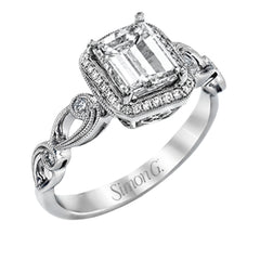 Reflecting a lovely romantic design, this white gold classic engagement ring features .16 ctw round cut white diamond accents.