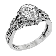 This amazing 18k white gold engagement ring features vintage-inspired design elements set with .28 ctw of white diamonds.