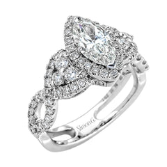 Reflecting an intricate modern design, this remarkable white gold ring is emphasized by a lovely halo complemented with .59 ctw round cut white diamonds.