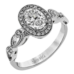 Reflecting a lovely romantic design, this white gold classic engagement ring features .16 ctw round cut white diamond accents.