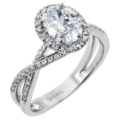 This sparkling modern engagement ring features an eye-catching twisted design with elegant classic halo accented by .29 ctw of shimmering round cut white diamonds.