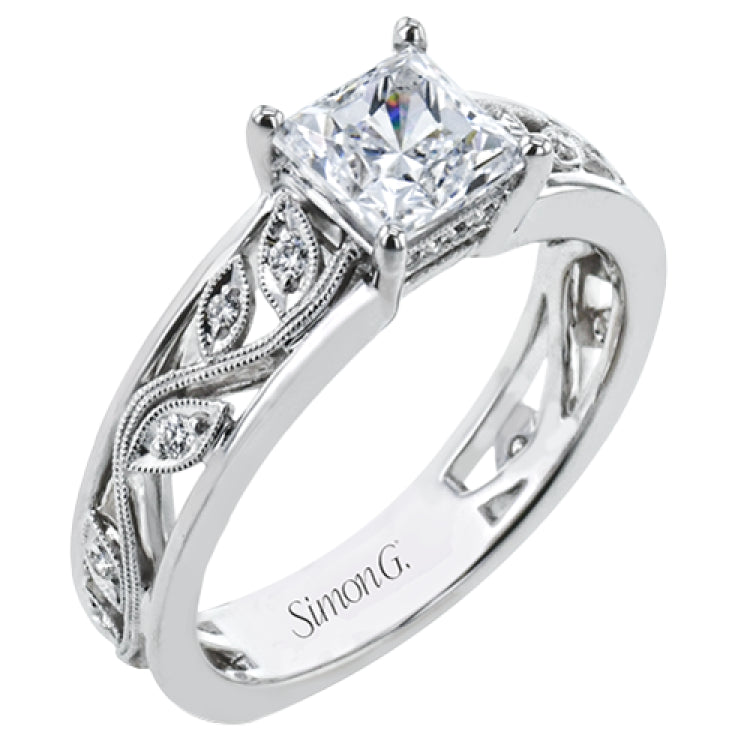 A delicate floral design highlights this vintage style engagement ring accented by .09 ctw of shimmering round cut white diamonds.
