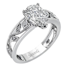A delicate floral design highlights this vintage style engagement ring accented by .09 ctw of shimmering round cut white diamonds.
