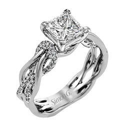This impressive contemporary white engagement ring features a unique twisting design on the shank, which is complemented by .17 ctw of round cut white diamonds.