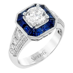 This stunning bridal ring design has a unique geometric halo set with 1.03 ctw of beautiful blue sapphires. The rest of the ring contains .52 ctw of white diamonds.