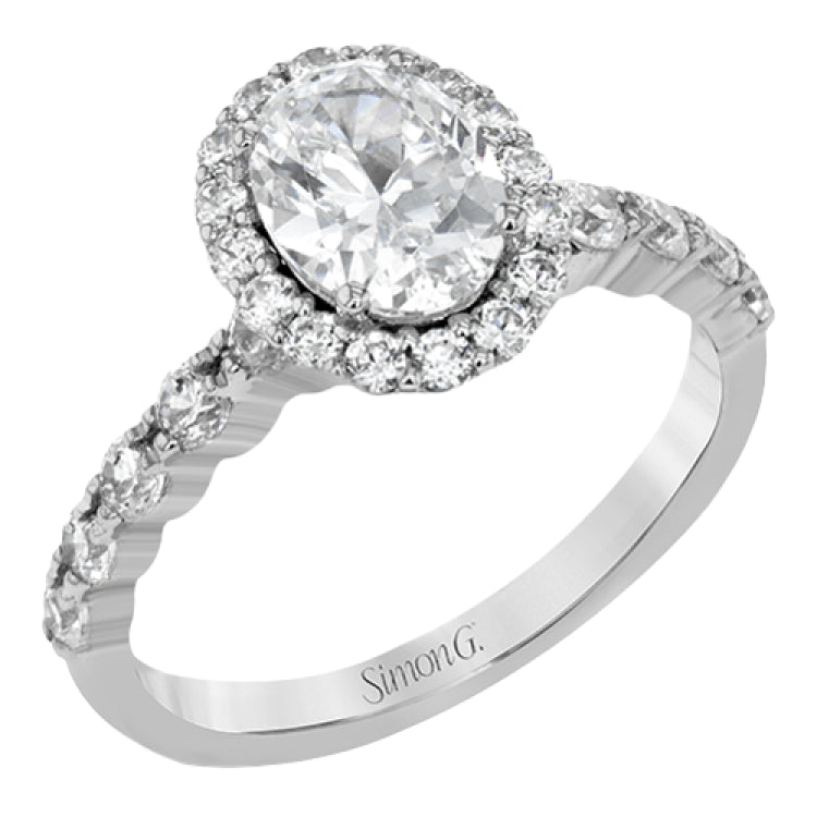 This white gold ring's clean, modern design features a halo and shank that dazzle with .70 ctw of round white diamonds.