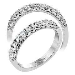 This classic wedding band features a distinctive setting style that shows off the .50 ctw of white diamonds to their full advantage.