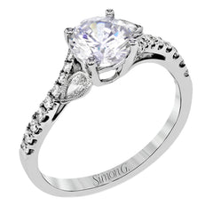 This lovely 18k white gold engagement ring contains .20 ctw of white round brilliant diamonds, highlighted by .10 pear shaped white diamonds.