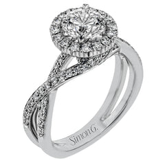 This sparkling modern engagement ring features an eye-catching twisted design with elegant classic halo accented by .29 ctw of shimmering round cut white diamonds.