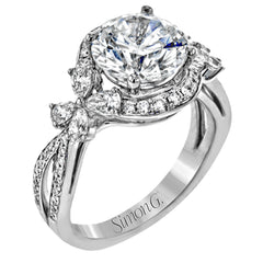Dramatic yet romantic, this exquisite white gold engagement ring features .61 ctw of round cut white diamonds highlighted by .58 ctw of pear shaped diamonds in delicate floral motifs.