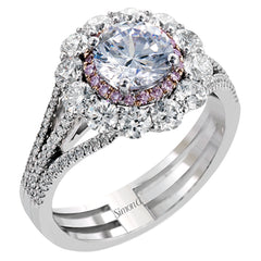 This lovely white gold contemporary ring features a dazzling halo of .10 ctw pink diamonds accented by 1.13 ctw round cut white diamonds.
