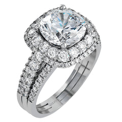 Featuring a brilliant halo setting, this contemporary white gold ring is set with 1.35 ctw glistening round cut white diamonds.