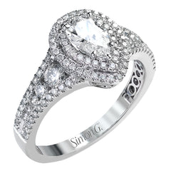Featuring a pear-shaped double halo, this modern white gold engagement ring is highlighted by .68 ctw of round cut white diamonds.