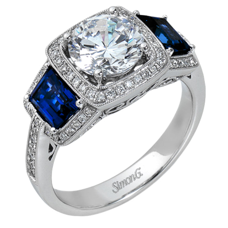 Featuring an elegant classic design, this white gold engagement ring is set with .23 ctw round cut white diamonds and side accents of .62 ctw trapezoid cut sapphires.