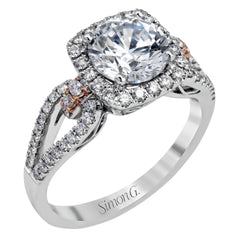 The delicate romantic design of this vintage inspired white and rose gold engagement ring and wedding band set is accentuated by .45 ctw of white diamonds and .08 ctw of pink diamonds.